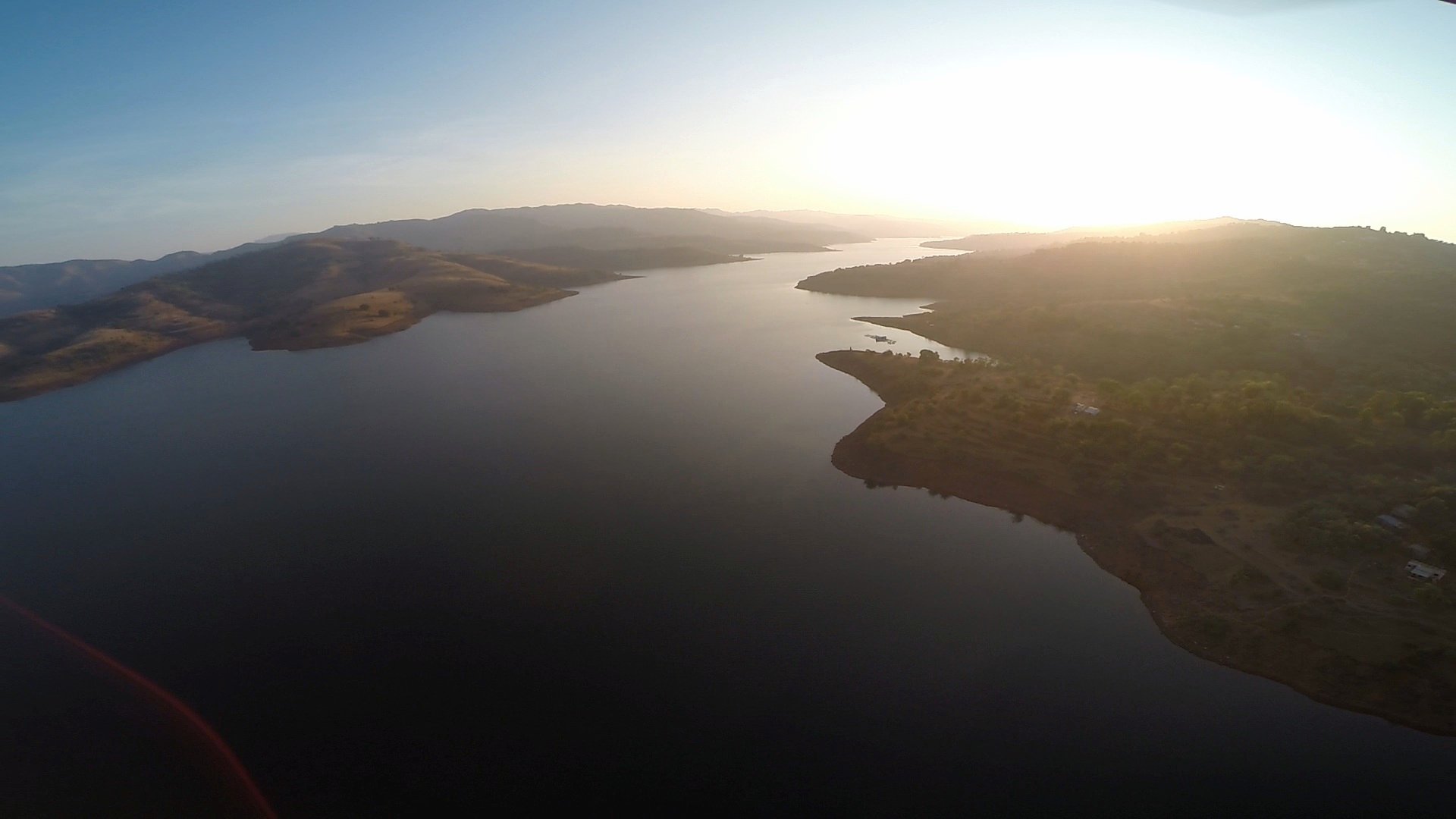 A river through the hills â€” a dam from the drone. â€” Maharashtra